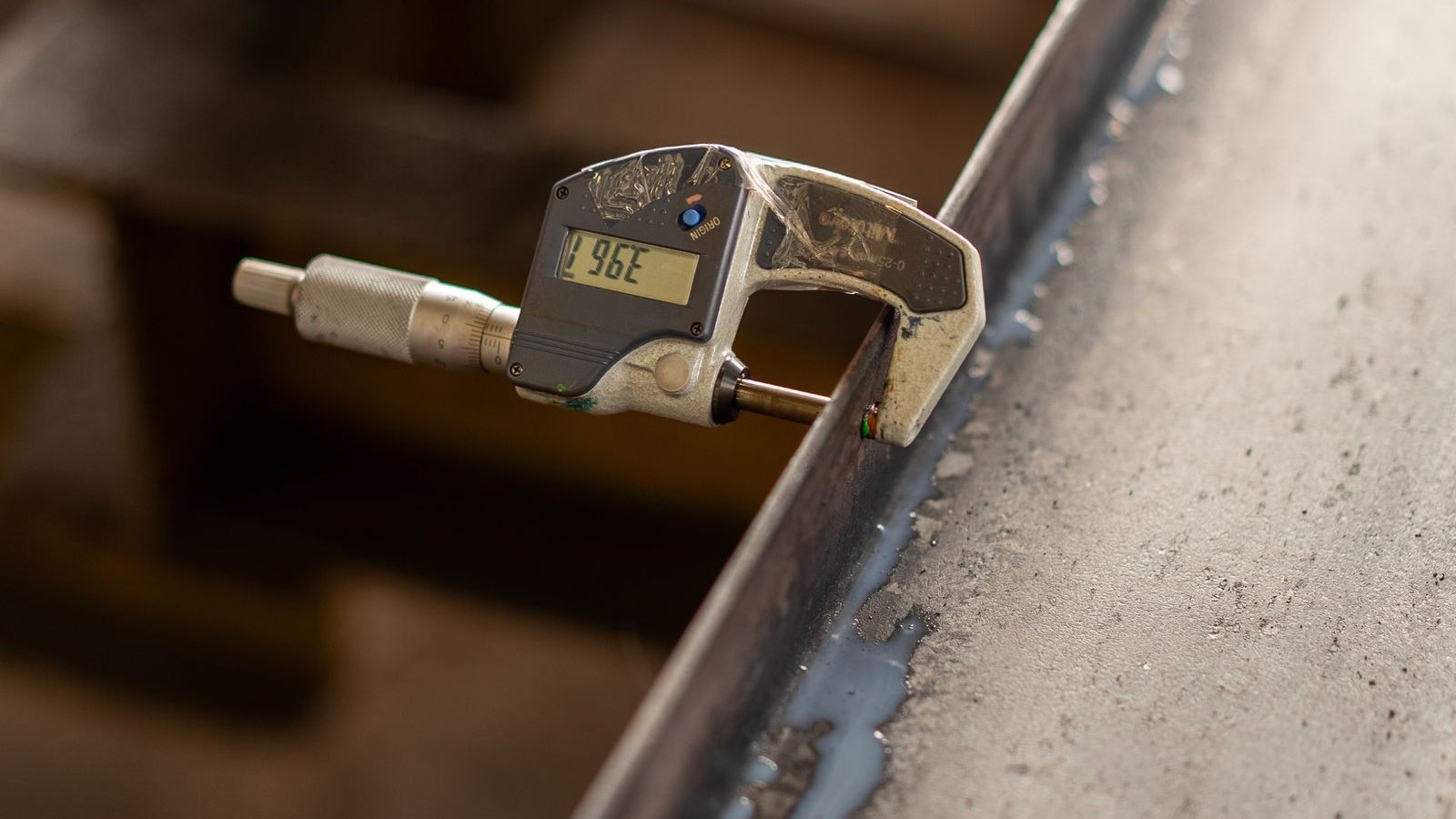Digital micrometer measuring a part